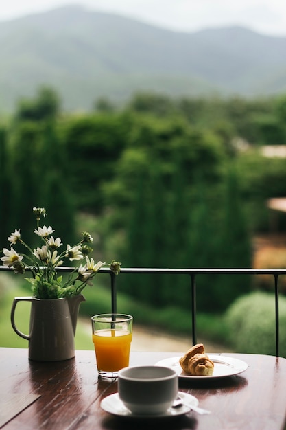 Free Photo breakfast on a wooden table with a natural view