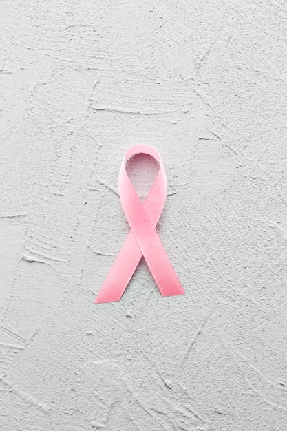 Free Photo breast cancer ribbon on plaster background