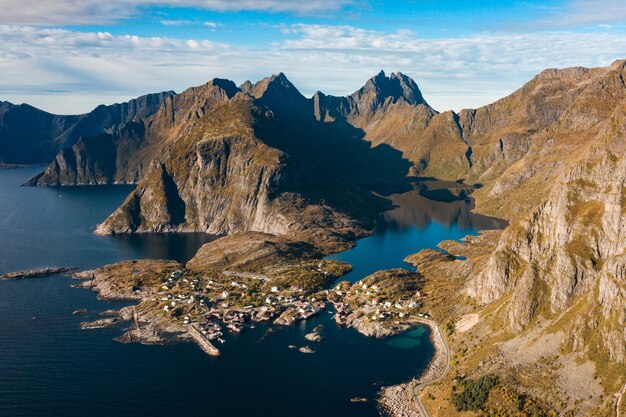 Breathtaking aerial shot of the mountainous landscape with high rocky mountains and the ocean