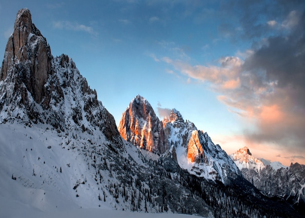 Breathtaking scenery of the snowy rocks under the cloudy sky in Dolomiten, Italy