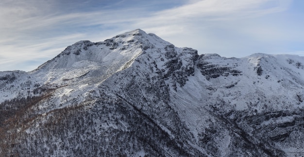 Breathtaking shot of the Ancares mountains covered with snow glimmering under the blue sky