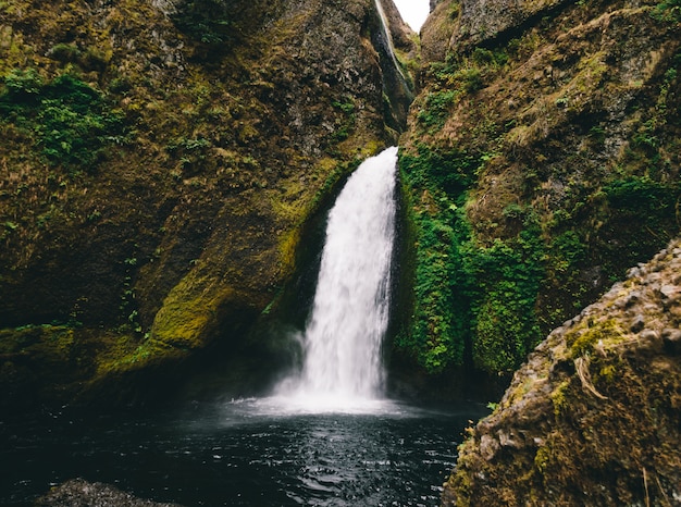 Free photo breathtaking shot of a small waterfall in the mountains