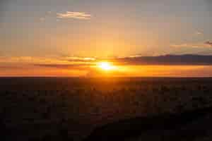 Free photo breathtaking sunset in the colorful sky over a desert in tsavo west, kenya, kilimanjaro