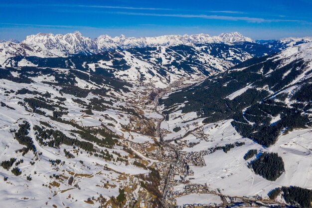 Breathtaking view of forested mountains covered in snow at daytime