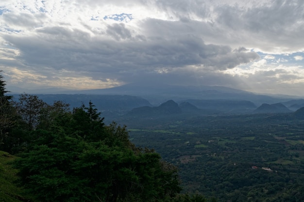 Breathtaking view of mountains and green forests with beautiful clouds