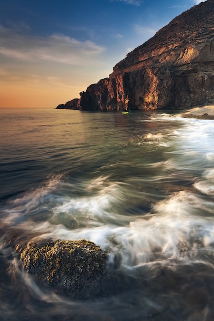 Breathtaking view of the seascape and rocks at the scenic dramatic sunset