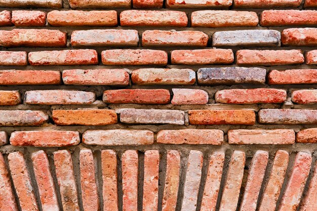 Brick facades of old houses renovation of houses in old cities The idea of a background or screensaver from red old brick wallpaper design for loft apartments