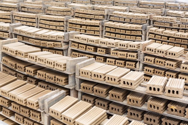 Free Photo brick piles placed on the factory floor.