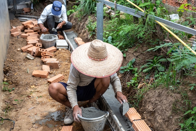 Bricklaying. Construction worker building a brick wall.