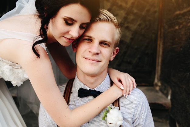 Free photo bride embraces groom with a flower