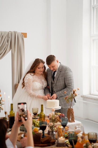 Bride and groom cutting the cake at their wedding