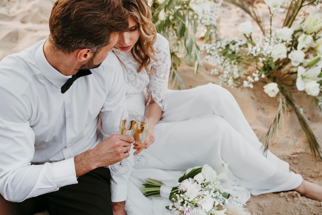 Bride and groom having their wedding at the beach