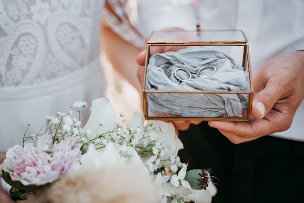 Bride and groom holding their rings