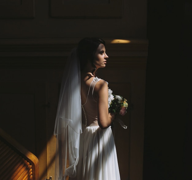 Bride and groom posing in the dimly lit room