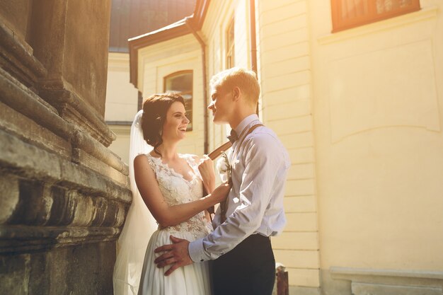 The bride and groom posing in the old street