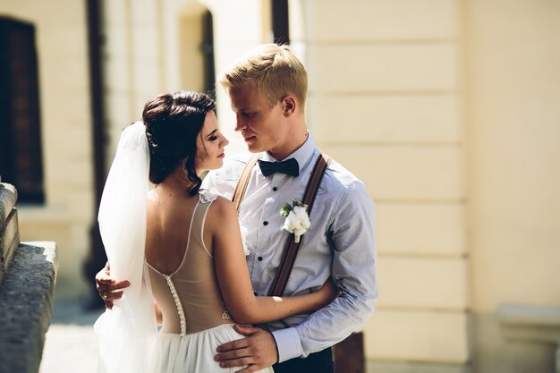 The bride and groom posing in the old street