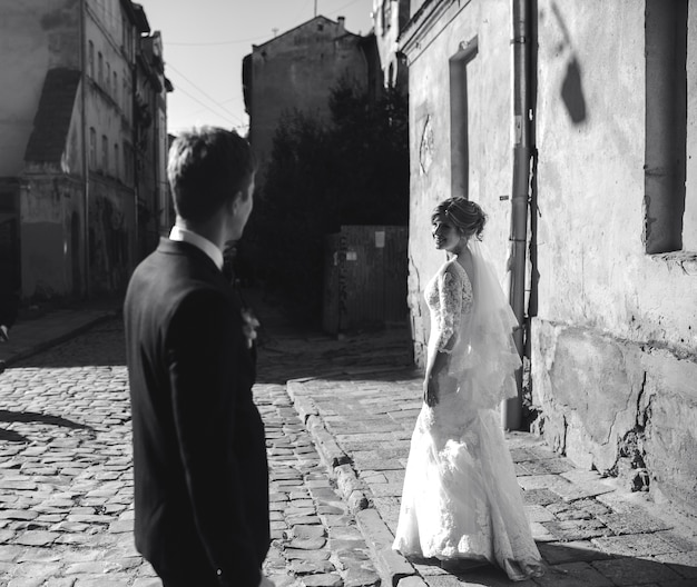 Free photo bride and groom posing on the streets of the old town