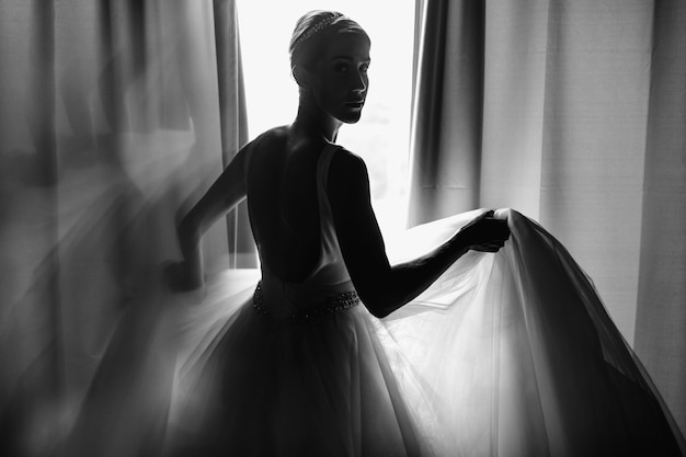 Free Photo bride's morning portrait. bride dressed like a balerina stands b