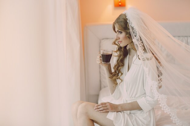 Bride sitting with a cup