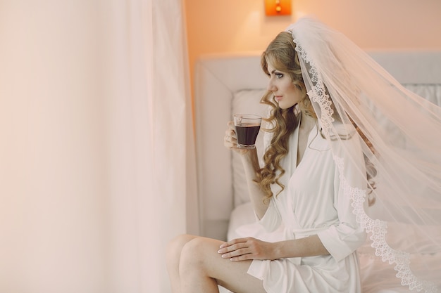 Bride sitting with a cup