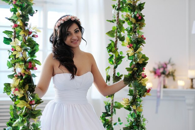 Free Photo bride on a swing with flowers