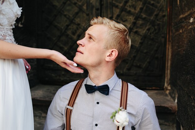 Bride takes the groom's face