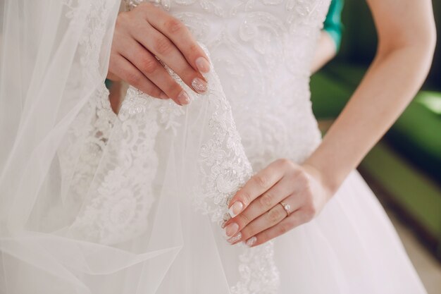 Bride touching his wedding dress