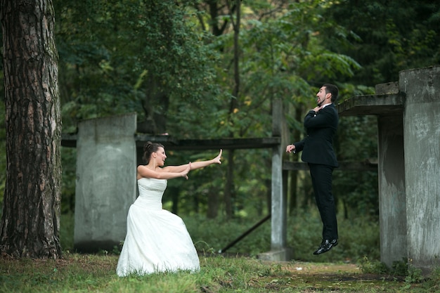 Bride using "force" lifting her boyfriend through the air