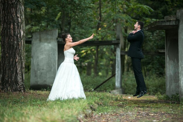 Bride using "force" lifting her boyfriend through the air