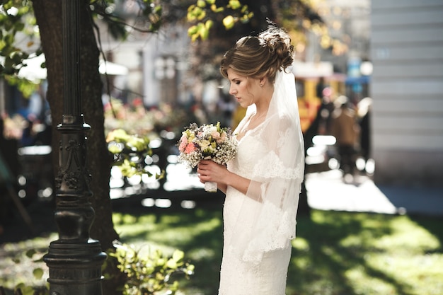 Bride waiting for the groom in the center of the old town