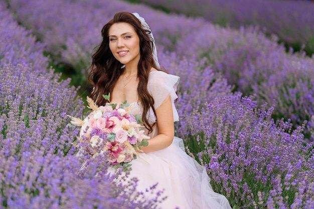 Bride in wedding gown posing in lavender meadow