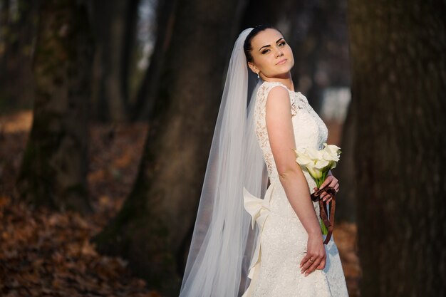 Bride with a bouquet in a forest