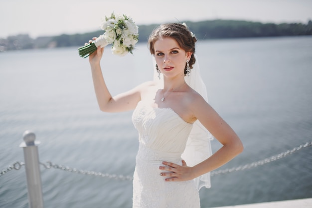 Bride with a bouquet in the sea