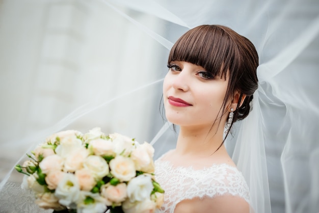 Free photo bride with a bouquet, smiling. wedding portrait of beautiful bride.