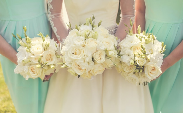 Bride with bridesmaids holding wedding bouquets