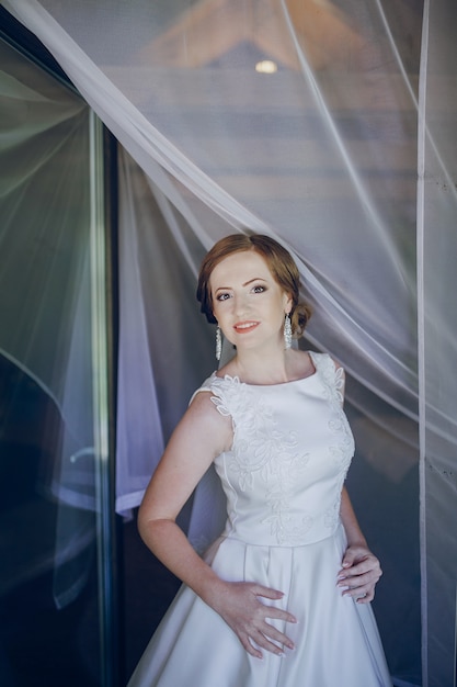 Free photo bride with curtains above