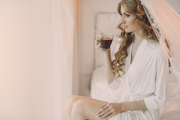 Bride with a transparent cup