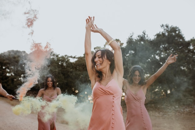 Free photo bridesmaids in pretty dresses celebrating the wedding outdoors