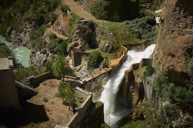 Free Photo bridge on a waterfall among green hills