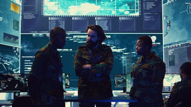 Free photo brigadier general and his staff studying radar data on a holographic image