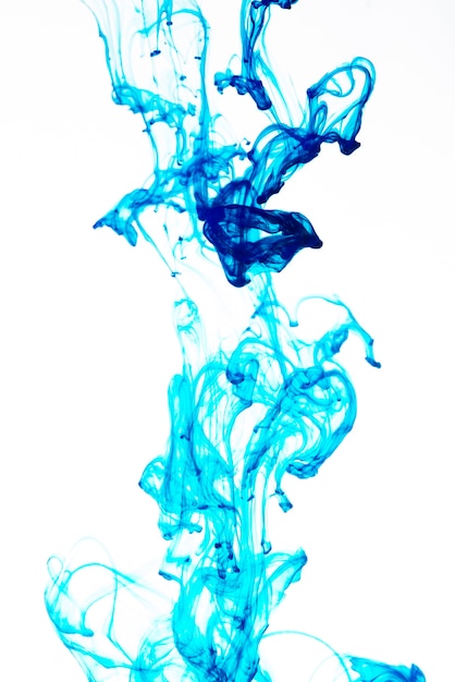 Free photo bright blue ink drop on white