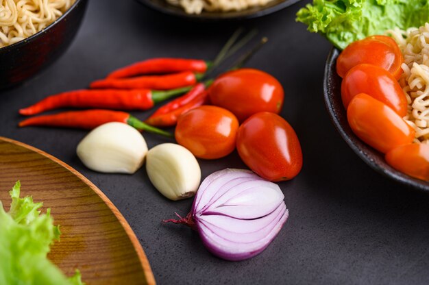 Bright close-up of red onion slices, garlic, tomato and peppers. Selective focus