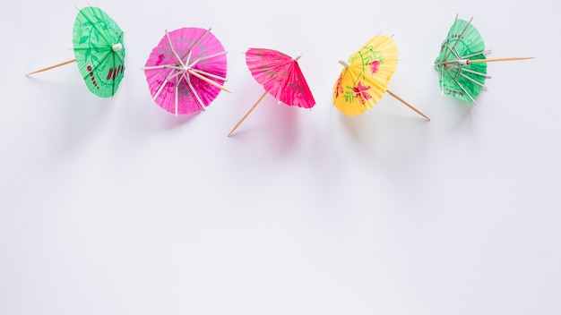 Bright cocktail umbrellas on table