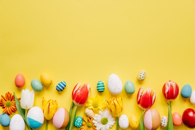 Bright colored eggs with flowers on yellow