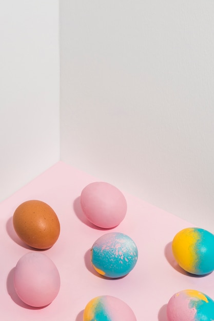 Bright Easter eggs scattered on table