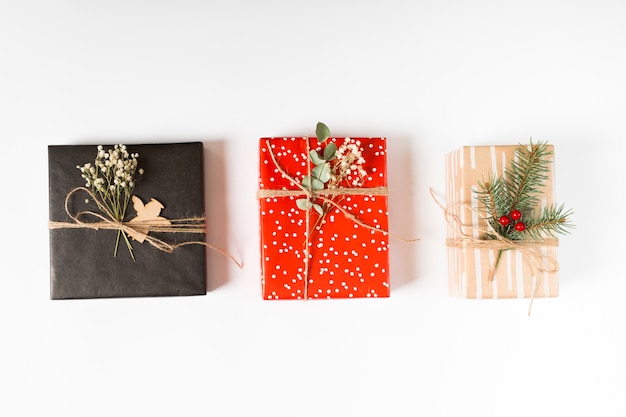 Free Photo bright gift boxes with branches on table 