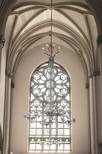 Free photo bright interior of the church with stainedglass windows view from below