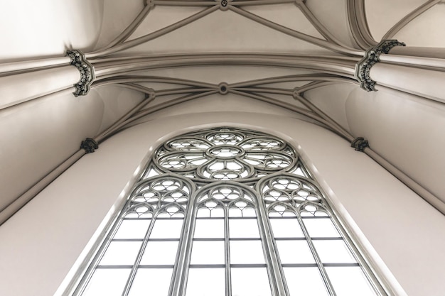 Free photo bright interior of the church with stainedglass windows view from below