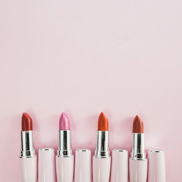 Free photo bright lipsticks in white tubes