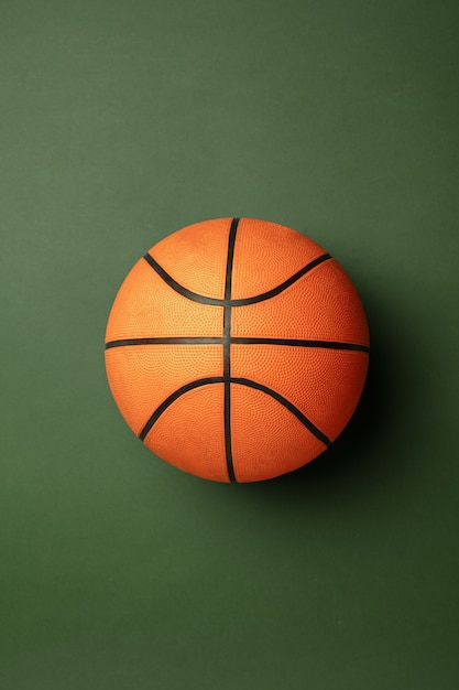 Free Photo bright orange-braun basketball ball. professional sport equipment isolated on green studio background. concept of sport, activity, movement, healthy lifestyle, wellbeing. modern colors.